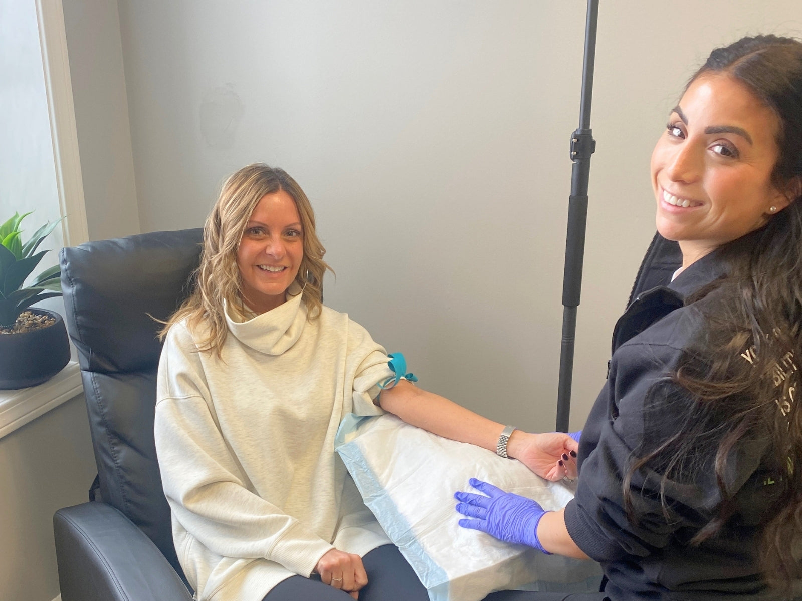 Woman receiving IV therapy with Sam, registered nurse, at Synergy Nutrition and Wellness in Western New York.
